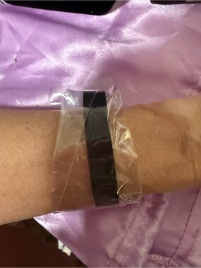 Black leather strap bracelet with gold hardware
